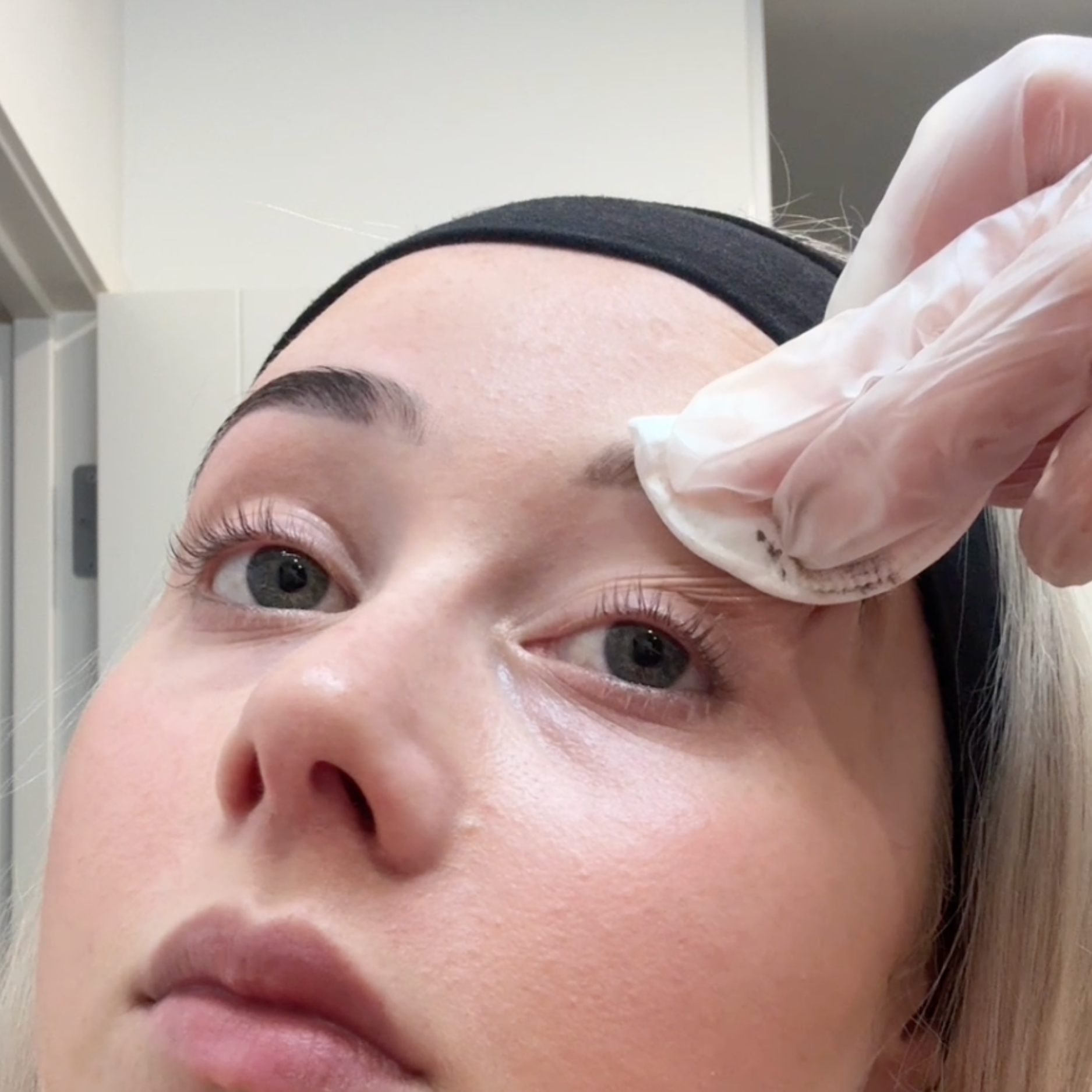 Person removing tint from eyebrows