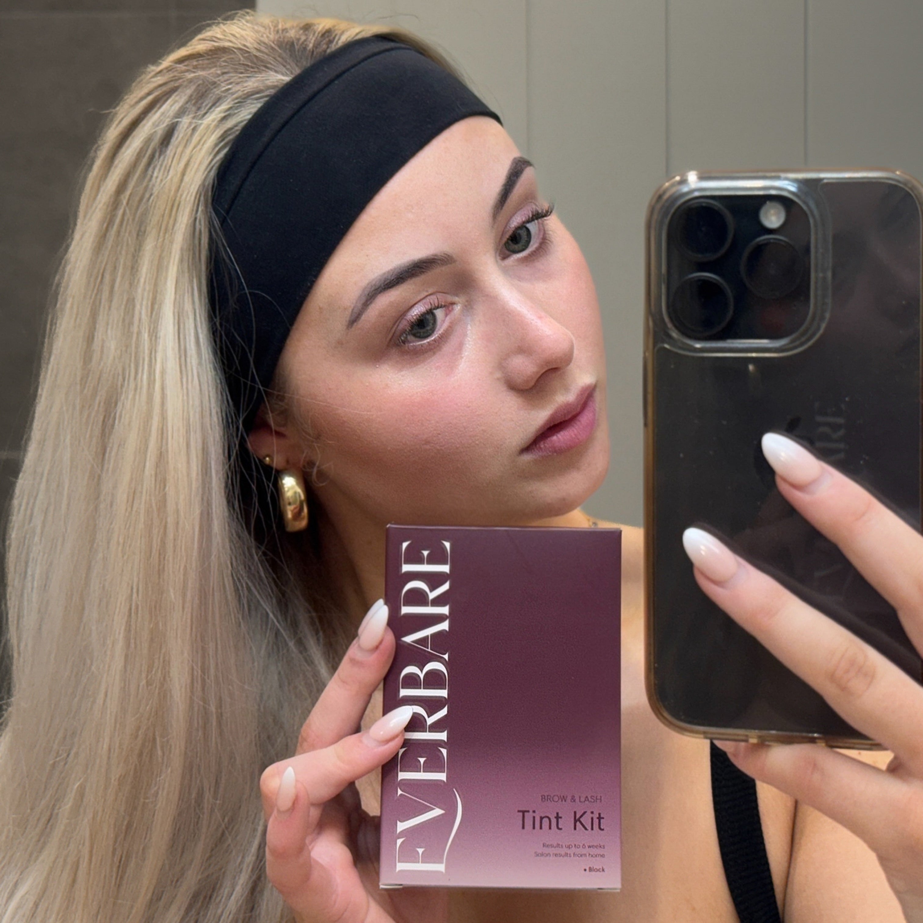 Person holding everbare Lash and brow tint kit for at home use 