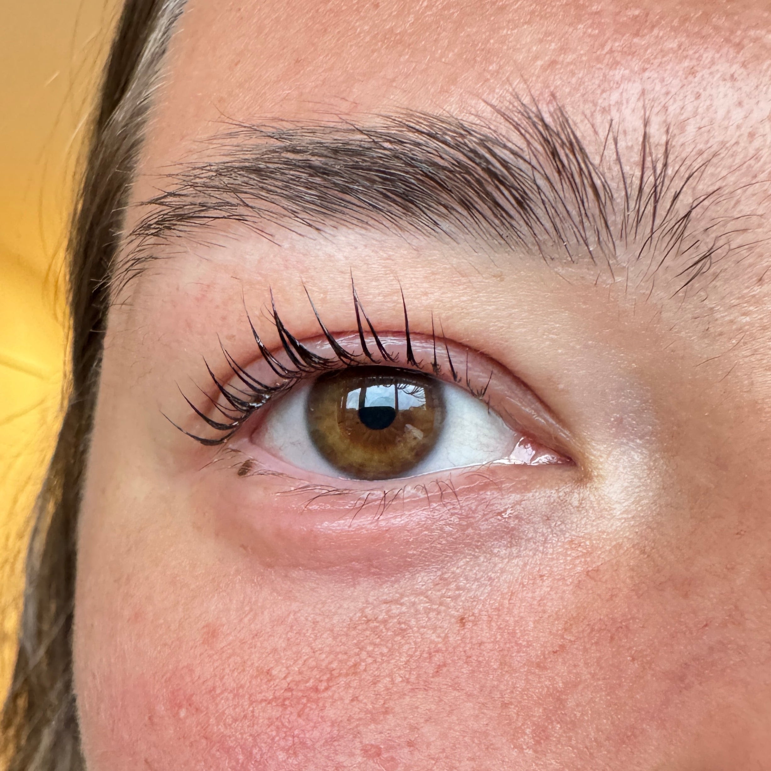 Eyelash lift kit for at home use close up of eyelash lift with brown eyes