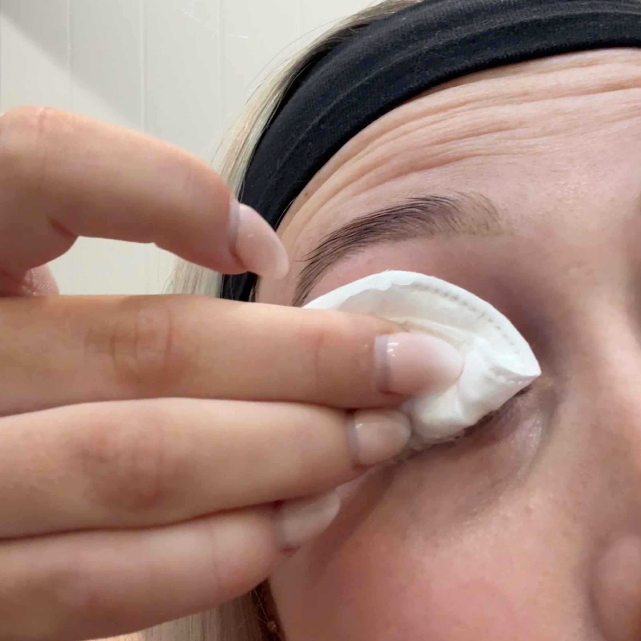 Person wiping eyes to clean their eyelashes